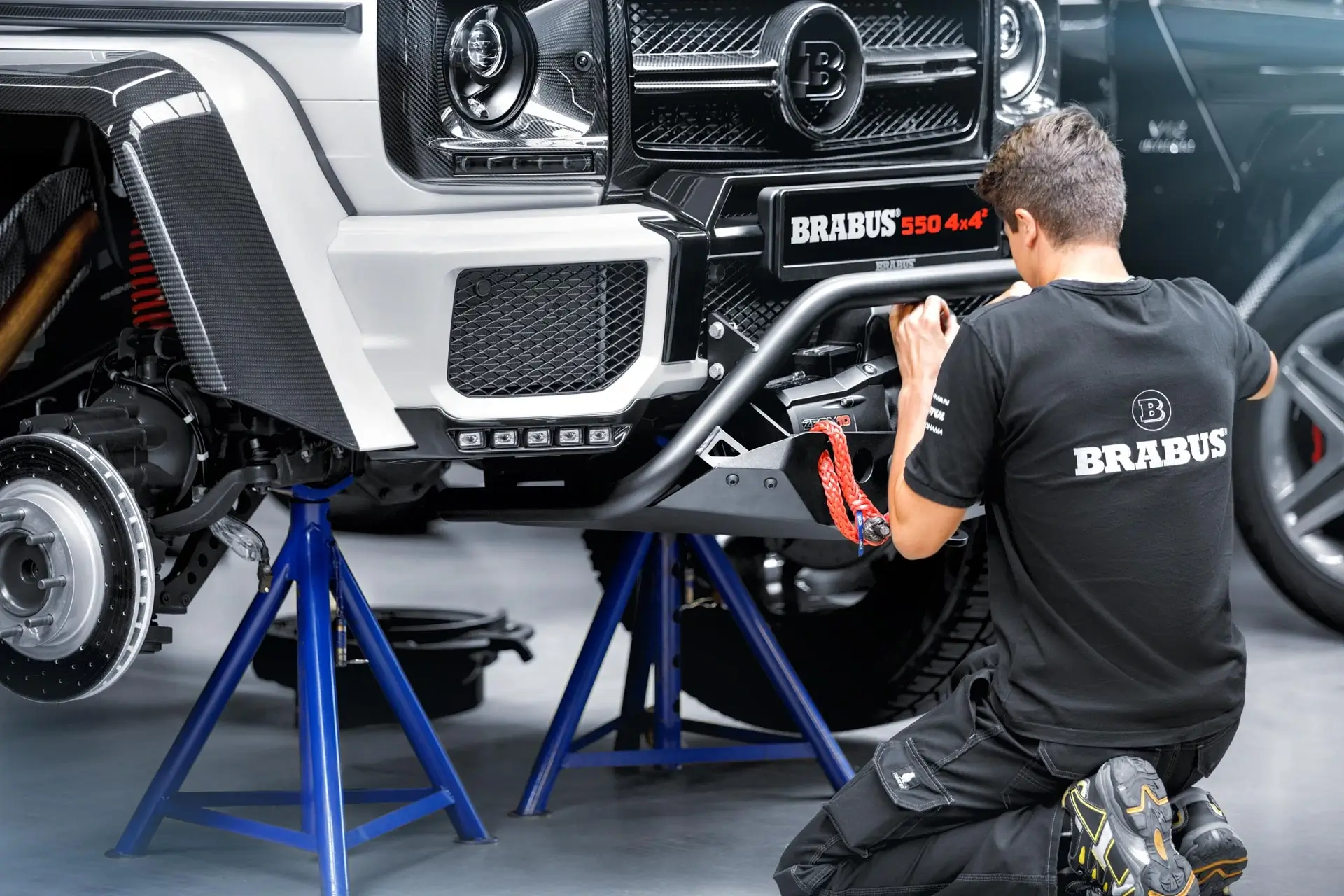 Image of a SkunkWorks visuals specialist working on a car front end