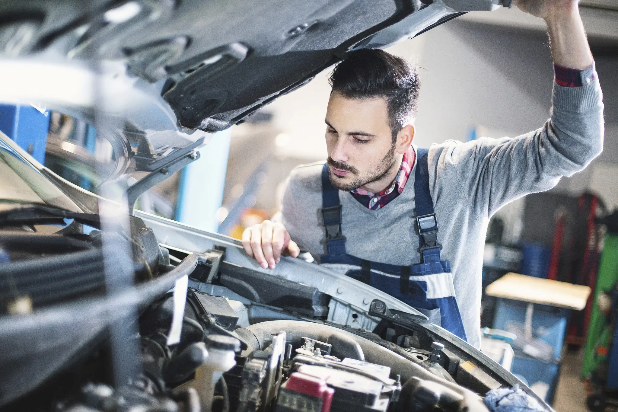 Image of a SkunkWorks mechanic specialist working on an engine